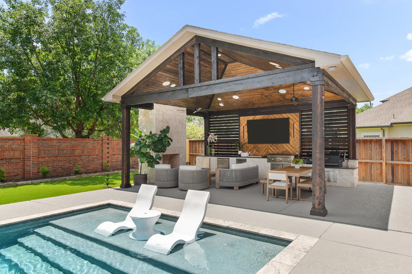 HPC gabled outdoor living pavilion with a fireplace and poolside seating